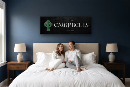 Celtic Cross family name canvas above a bed on a navy bedroom wall