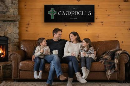 Celtic Cross family name canvas on a timber cabin wall above a leather sofa