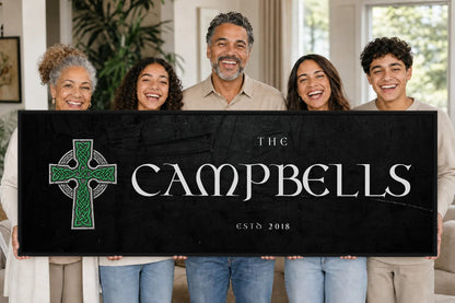 A smiling family holding their personalized Celtic Cross canvas in the living room