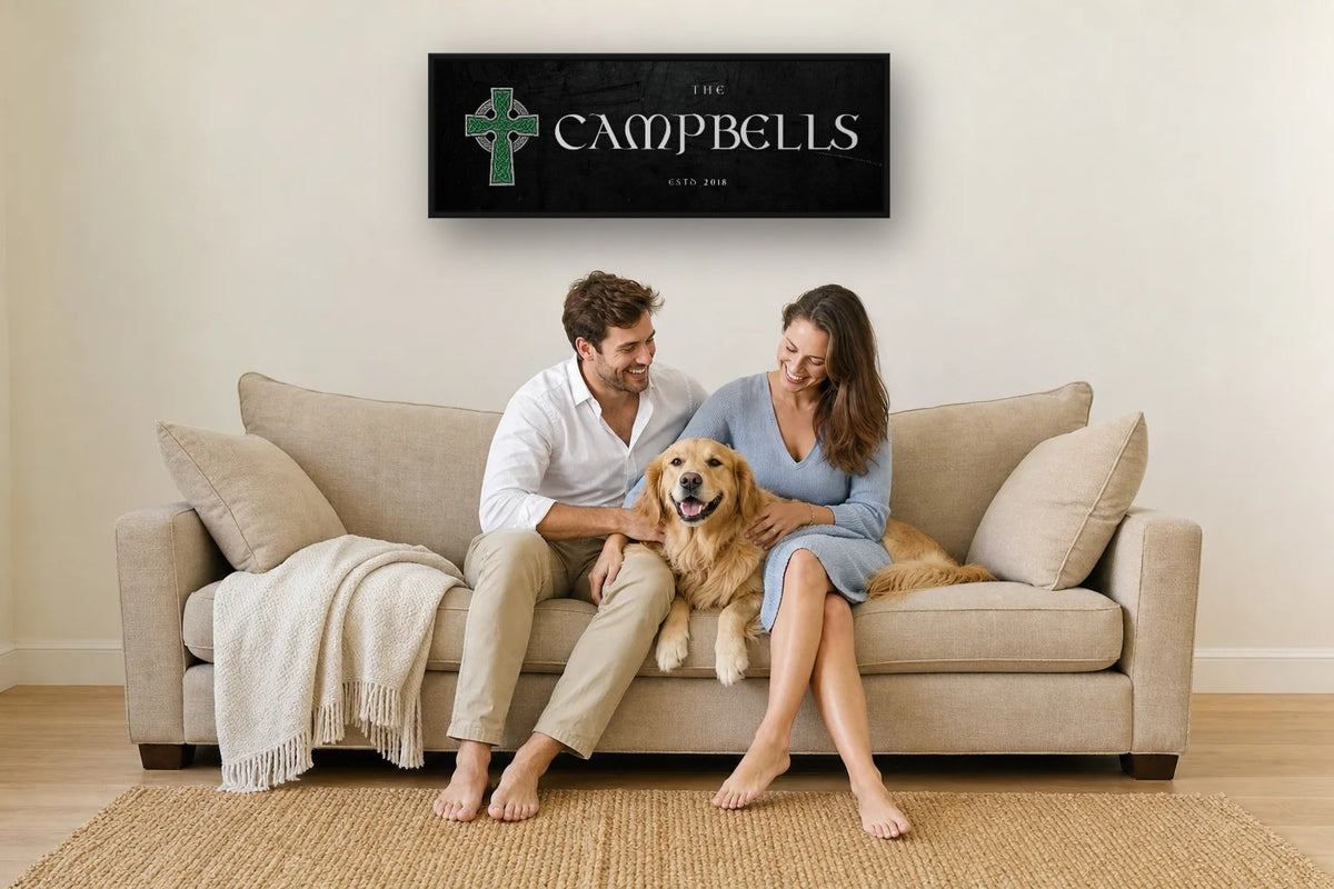 Celtic Cross family name canvas above a sofa, with a couple and their dog