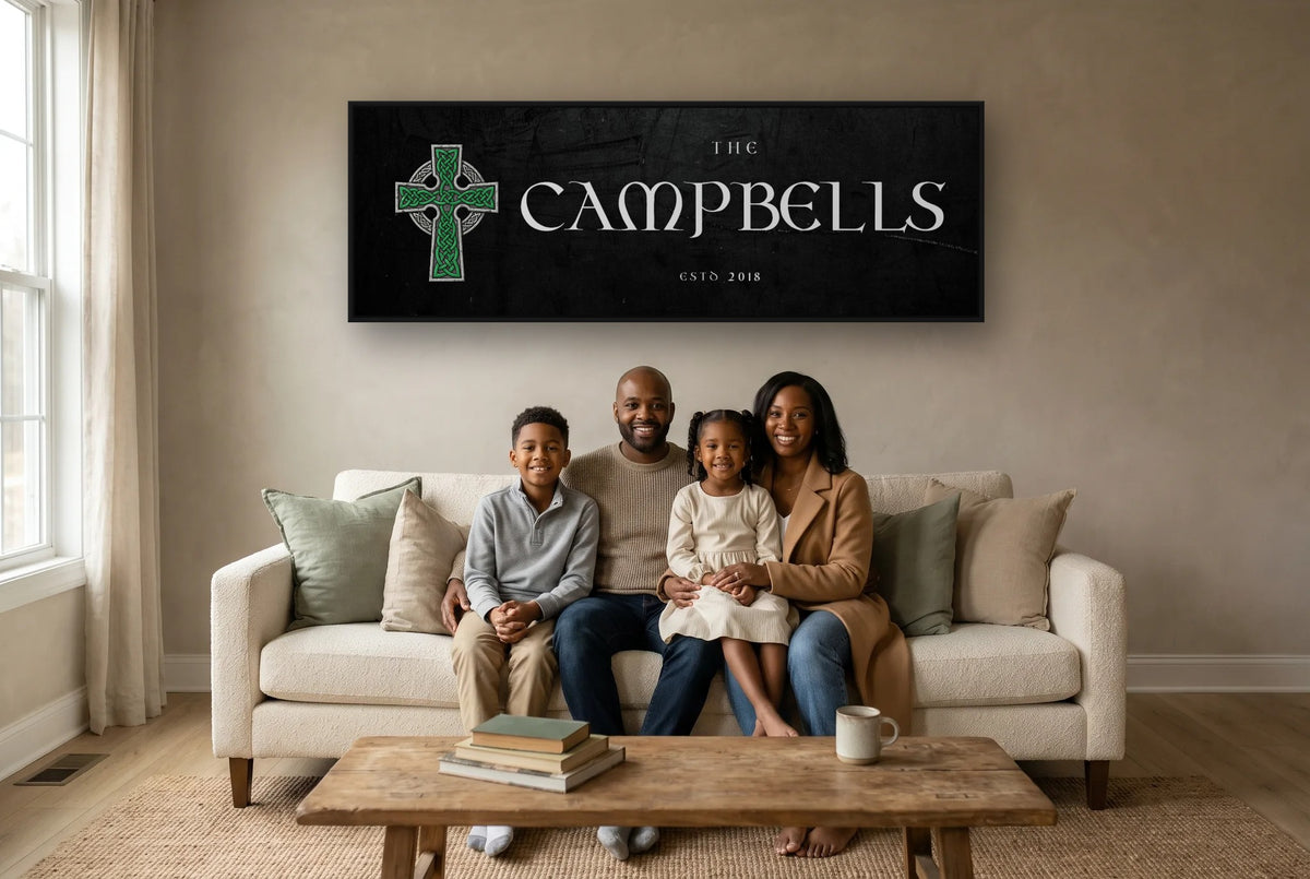 Personalized Celtic Cross family name canvas in a black frame above a sofa, with a family sitting below